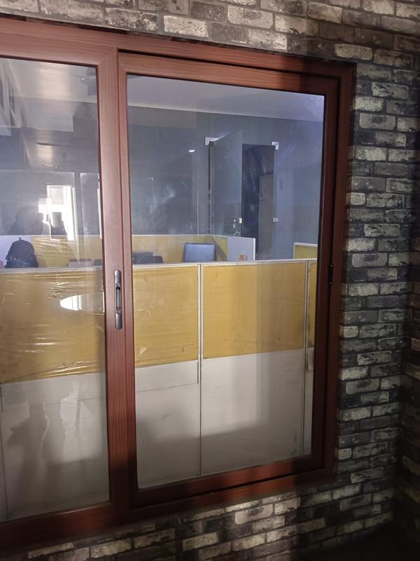 The Aluminium Powder Coated Wooden Finish Domal Aluminum Windows represent a sophisticated and versatile solution for both residential and commercial spaces, blending the durability of aluminum with the aesthetic appeal of a wooden finish. Designed with modern sensibilities in mind, these windows enhance the overall ambiance of homes and offices.Material and Construction, Aesthetic Appeal, Versatility ,Functionality ,Contemporary Design ,Durability and Low Maintenance ,Application Areas:,Energy Efficiency, Customization Options.these windows offer a harmonious balance between style and practicality.