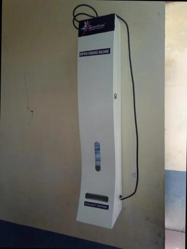 Napkin Vending Machine By A Button PressManufacturer of a wide range of products which include napkin vending machine by a button press.SPECIAL FEATURES: Construction : Powder coated sheet metalDispensing rate : Dispense one napkin at a time.Loading style : Vertical and front loadingLock with a key : Provided Mounting type : Wall mounting unitNapkin Window : To view the availability of the napkinsOperation : Fully automatic– by button pressHolding Capacity : 40 napkins ( 280 mm X 7mm thickness)Dimension : L 180 mm X B 155 mm X H 980 mmWeight : 9.4KgPower : 230 / 110 v / 50 Hz Single Phase 5A· Vends a napkin by just a button press. · Maintenance free · Vends a napkin by just a button press.· Maintenance free