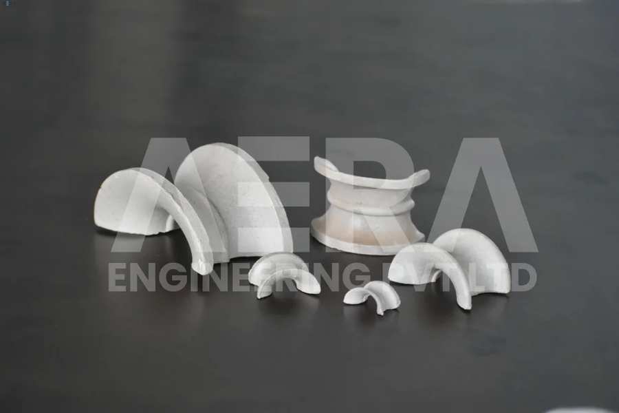 AERA CERAMIC SADDLES equivalent to intalox saddle write are a type of structured packing material used in various chemical and industrial processes, including distillation, absorption, and stripping columns. They are designed to provide a large surface area for improved mass transfer and separation efficiency.AERA Ceramic saddles are shaped like small, hollow cylinders with a curved top and a flared base, resembling a horse saddle. They are typically made of high-quality ceramic materials, such as porcelain or alumina, which offer excellent chemical resistance, thermal stability, and mechanical strength.The distinctive shape of AERA ceramic saddles allows for the creation of a large internal void space and a significant surface area. This design facilitates the flow of liquid and gas within the column, promoting effective contact and mass transfer between the phases. The curved top of each saddle provides increased surface area for the liquid film to spread, while the flared base allows for even gas distribution and reduced pressure drop.The key advantage of AERA ceramic saddles lies in their ability to achieve high separation efficiency while maintaining a low pressure drop across the column. The structured packing arrangement of the saddles promotes uniform distribution of the liquid and gas phases, minimizing the risk of channeling or preferential flow paths. This uniform flow distribution enables better utilization of the column's capacity and enhances the overall separation performance.AERA Ceramic saddles are particularly suitable for applications that involve corrosive or high-temperature environments. Their ceramic construction provides exceptional resistance to a wide range of chemicals and can withstand high operating temperatures. This makes them ideal for processes involving aggressive or challenging process streams.