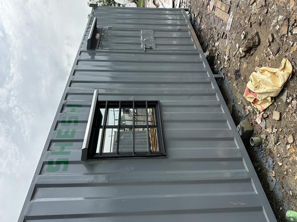 A portable office cabin full furnished for staff. This material use GI sheet 1 mm thickness base structure use material MS I Beam 100x50 5 mm thickness side post square pipe 63x63 2.5mm thickness top structure square pipe 50x50 2 mm thickness Internal material use MDF sheet 8mm with Glass wool 16/25 all electrical fittings with concealed wiring and out side paint epoxy primer and paint.