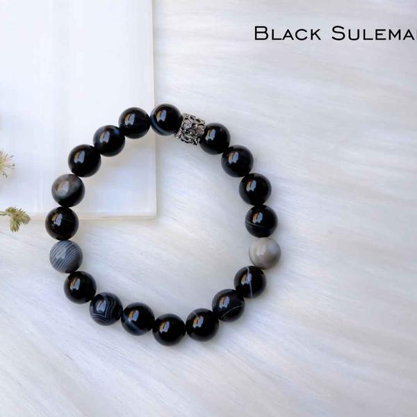 Black Sulemani is one of the most popular protection crystal. A variety of Black Onyx this has the energies to cleanse and remove psychic attacks and helps to keep the energies clean and grounded. Also effective for protection from black magic.Additional Information:8mm genuine gemstone beads Strung on durable stretchy cord Unisex Sizing Stone colors may vary Shipping time 5 working days minimum