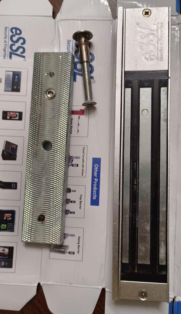 Electromagnetic Lock (EM Lock)The EM Lock is a high-quality, secure locking device designed for access control systems. It uses powerful electromagnetic force to secure doors, offering a strong and reliable solution for various entry points. When the system is engaged, the magnetic lock holds the door firmly closed, preventing unauthorized access. Once the system is released, the door opens smoothly, providing convenient and safe access.Key Features:Strong Holding Force: Available in multiple holding force options (typically 300 lbs, 600 lbs, or 1200 lbs) to suit different security requirements.Durable and Reliable: Built from robust materials for longevity and consistent performance, even with heavy use.Fail-Safe Mechanism: Automatically unlocks during power outages, ensuring safety and compliance with fire exit regulations.Easy Installation: Comes with mounting hardware and instructions for straightforward setup on most types of doors.Compatibility: Works seamlessly with access control systems, including biometric, keycard, and keypad entry methods.Applications: Ideal for offices, banks, hospitals, labs, server rooms, and other secure areas that require controlled access. The EM Lock offers a balance of safety, durability, and convenience, making it an essential component in modern security infrastructure.