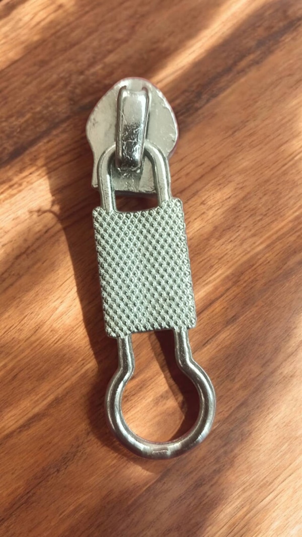 This fancy slider used in bags combines functionality with style, often designed to add a distinctive, high-end touch to the overall look of the bag. These sliders not only serve to open and close zippers but also contribute to the aesthetic appeal of the bag.This fancy slider adds luxury, visual appeal, and exclusivity to a bag while ensuring it remains functional. The combination of high-quality materials, intricate designs, and attention to detail transforms an otherwise simple zipper mechanism into an eye-catching element that enhances the bag’s overall aesthetic.