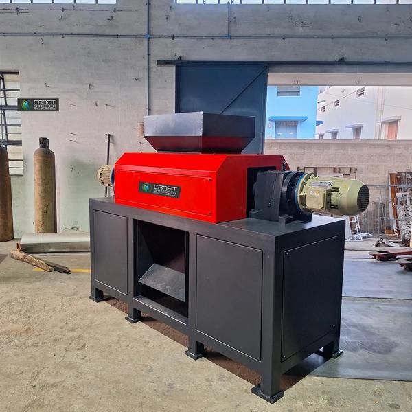 Scrap Metal Waste Shredder In Coimbatore | Craft Shredders With larger rotor diameter and conveyor belt cutout         The CD-M 1.074 Double-shaft shredder is ideal for processing almost all plastics and paper as well as hard and resistant materials. These machines can shred cable drums, pet bottle, RDF, plastic paper, building blocks, and even sheets, automotive parts, blow molded materials like car body scrap, medium-size commercial scrap, canisters, buckets, (bicycles, rickshaw body), and light metals. Different configurations ensure optimum adaptation to every application. The shredder can also be ideally integrated into a two-stage solution.Flexible control for changing material flowsCRAFT only requires one control panel to precisely control one or more machines including the conveyor system. The built-in CG PLC control is optimally adapted to the shredding process. Various slide controls and rotor settings can be conveniently adjusted to the desired application. All control cabinets are designed in-house and built in our INDIA production facilitiesFlexible control for changing material flowsCRAFT only requires one control panel to precisely control one or more machines including the conveyor system. The built-in CG PLC control is optimally adapted to the shredding process. Various slide controls and rotor settings can be conveniently adjusted to the desired application. All control cabinets are designed in-house and built in our INDIA production facilities.Technical specificationsBased on the principle of speed and high torque, double shaft shredder are extremely versatile shredders that are designed to bulky material. They are easy to operate and requir minimal supervision. being significantly rugged with a strong support structure, these shredders are noted for their performance, durability, and reliability and are ideal for challenging applications. Pre shredderIncludes rotary shear (double shaft shear) which cuts and crushes voluminous light metal scrap like automobile body, drum with goods body, etc into small pieces. it has two rotors driven by motors and gearbox and can bear abnormal load conditions and pre-shred without causing significant noise or polluting the air.Shredder Chassis designThe whole chassis is made of welded steel plate and finely machined by vmc gantry milling which has high bearing capacity high impact resistance and more stable quality.Offset rotor bearings Protect against dust and foreign matterThe shredding of particularly resistant materials requires correspondingly robust bearings that are easy to maintain. CRAFT uses long-life, spherical roller bearings, whose stable design and offset mounting Their additional shaft seal ring effectively helps against the intrusion of contaminants or dust.Shredder SpindleThe Shredder spindle is made of high alloy, forged and heat-treated and tempered as a whole, and then machined into hexagonal, octagonal and spline form by CNC gantry milling after fine turning, with long service life.Robust electromechanical drive with planrtary gearboxFor most applications, electromechanical drives are the classic choice because they are easy to maintain and robust. CRAFT's special manufacture branded gearboxes that are specially designed for shredding operations. Torque monitoring and shock-absorbing vibration dampers round off the package. A hydrodynamic start-up clutch is available as an option for further protection of the machine.In stock GuaranteeWe carry a complete line of replacement parts for all CRAFT Equipment with shipping on standard parts within 24 hours. We also provide field service Technicians support if your equipment needs maintenance or repairs. Depending on location,our technicians can generally be on your site within 24 hours.