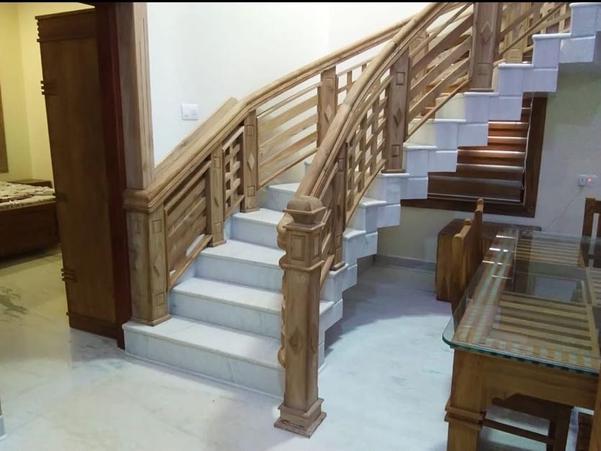 An Elegant Staircase Railing Design Using Nilambur Teak Wood Can Be Tailored to Suit a Variety of Interior Styles, from Classic to Contemporary. Here Are Some Design Ideas to Inspire:Minimalist Modern DesignSleek, Straight Lines with a Smooth Finish.Thin, Vertical Teak Wood Balusters Spaced Evenly for a Clean, Uncluttered Look.a Polished Teak Handrail with Rounded Edges for Comfort and Style.