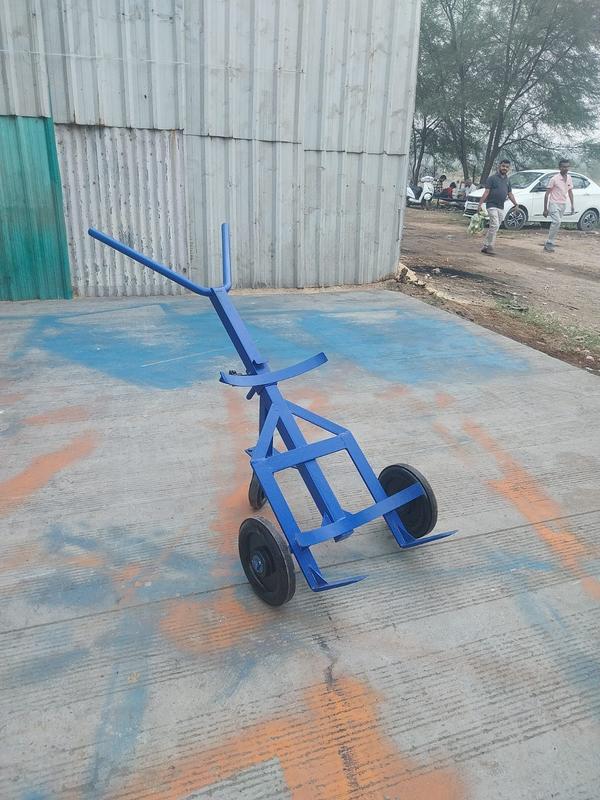 3 Wheel Drum Lifter Manufacturers in AhmedabadWe are also supply in Andhra Pradesh, Arunachal Pradesh, Assam, Bihar, Chhattisgarh, Goa, Gujarat, Haryana, Himachal Pradesh, Jharkhand, Karnataka, Kerala, Madhya Pradesh, Maharashtra, Manipur, Meghalaya, Mizoram, Nagaland, Odisha, Punjab, Rajasthan, Sikkim, Tamil Nadu, Telangana, Tripura, Uttar Pradesh, Uttarakhand, and West BengalA 3-wheel drum lifter is a specialized material handling device designed for lifting, transporting, and positioning heavy drums safely and efficiently. These lifters are commonly used in industries such as manufacturing, chemical processing, food production, and warehousing. They allow workers to move steel, plastic, and fiber drums without requiring excessive manual effort, reducing the risk of workplace injuries.One of the key features of a 3-wheel drum lifter is its sturdy three-wheel design, which provides stability and maneuverability. Unlike traditional two-wheel lifters, the third wheel adds balance, ensuring that the drum remains secure during transportation. The wheels are often made of durable materials such as polyurethane or rubber to provide smooth movement on various surfaces.These lifters typically have a clamping mechanism that securely grips the drum. Depending on the model, the clamp may engage with the top, middle, or bottom of the drum to ensure a firm hold. Some advanced models feature automatic gripping mechanisms that lock onto the drum when lifted, making the operation more user-friendly.