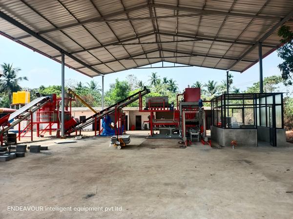 Fully Automatic Fly Ash Bricks & Solid Blocks Plant with Automatic Materials Batching & Feeding System & Automatic Pallet Stacker Installed in KarnatakaModel: ENDEAVOUR-iF5000Production Capacity:Bricks Size: 230 X 100 X 75 mm - 24 Bricks per Stroke / 4200-4800 Bricks per HourSolid Blocks Size: 400 X 100 X 200 mm - 10 Blocks per Stroke / 1000- 1300 Blocks HourSolid Blocks Size: 400 X 150 X 200 mm - 8 Blocks per Stroke / 800- 1000 Blocks HourSolid Blocks Size: 400 X 200 X 200 mm - 8 Blocks per Stroke / 800- 1000 Blocks HourPressing Capacity: 250 Tons Max.Pan Mixer Capacity: 2000 Kgs per BatchHydraulic Tank Capacity: 300 LtrsControl Panel: User Friendly PLC Based Control Panel with Touch Screen DisplayPallet Size: 830 X 1100 X 32 mmConnected Power: 136.00 HP / 102.00 KW / 3 Phase / 440 Volts / 50 HtzMajor Units:Three Bin FeederWeighing HopperRaw Materials Transfer ConveyorCement Feeding HopperCement Feeding Screw ConveyorCement Weighing HopperPan MixerMixed Materials Transfer ConveyorMixed Materials Box FeederHeavy Duty Hydraulic Bricks Press - 225 Tonn Pressing CapacityAutomatic Pallet StackerDetails & Specifications are subjected to change without Prior Notice.