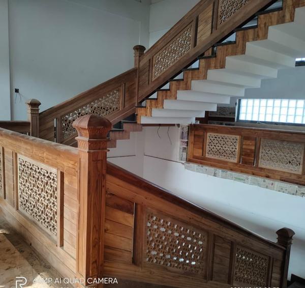 Designing a full teak wood staircase involves combining functionality, aesthetics, and craftsmanship. Teak wood is a premium material known for its durability, natural beauty, and resistance to moisture, making it an excellent choice for staircases.A Leading Teak Wood Interiors We Provide Affordable Cost And No Compromise in Quality In Works,Original Nilambur Teak Wood Only For All.Design ConsiderationsSpace and Layout: Measure the available space and determine the staircase's dimensions (height, width, and number of steps).Style: Choose a design style that complements your interior (e.g., modern, traditional, minimalist, or rustic).Functionality: Ensure the staircase is safe, comfortable, and easy to navigate.Building Codes: Adhere to local building regulations for staircase dimensions, railing height, and tread depth.Types of Teak Wood Staircase DesignsStraight Staircase: Simple and classic, ideal for smaller spaces.L-Shaped Staircase: Features a 90-degree turn, often with a landing.U-Shaped Staircase: Includes two flights of stairs with a 180-degree turn.Spiral Staircase: Compact and elegant, perfect for limited spaces.Floating Staircase: Modern design with treads appearing to