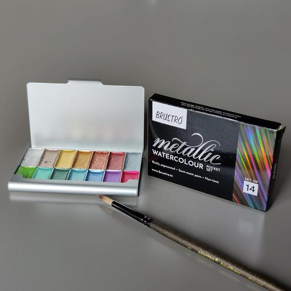 BRUSTRO Artists Metallic Watercolour Pocket Set of 14 Half Pans | Richly Pigmented, Semi Moist Pans, Ideal for Still life, Portrait, Landscape, Watercolour Paintings. Brustro Metallic Watercolours are made of mica pigments and gum arabic. 14 Richly pigmented colours with a beautiful metallic sheen. Semi most pans which activate very easily with a wet paint brush. Works both on light and dark coloured papers. Ideal for highlights, calligraphy, card making and all watercolour techniques. The tin box has a magnetic lid and pans are also magnetically placed which gives more stability and access. The set includes Gold Deep, Bronze Shimmer, Copper Shimmer, Graphite Metallic, Moss Green, Mystic Blue, Sapphire Blue, Amethyst Purple, Electric Orchid, Rustic Ruby, Minty Metallic, Silver Moonbeam, Champange Gold & Sparkling Grass.