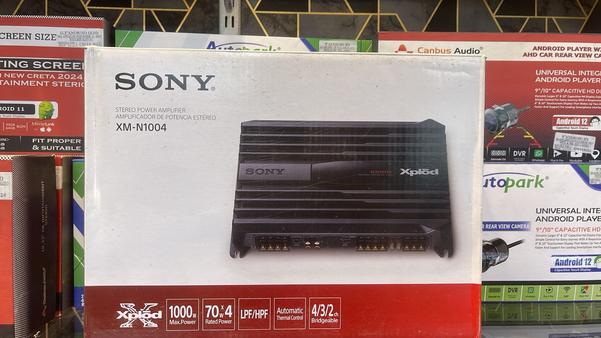 Upgrade your car’s audio system with the SONY® XM-N1004 Stereo Power Amplifier, engineered for crystal-clear sound, high power output, and deep bass. Whether you’re an audiophile or simply love immersive sound, this 4-channel car amplifier ensures exceptional sound clarity and performance.🔹 Key Features:✔️ 1000W Peak Power Output – Delivers powerful and distortion-free sound✔️ 4-Channel Configuration – Supports multiple speaker and subwoofer connections✔️ High & Low Pass Filters – Enhanced audio tuning for deep bass and crisp highs✔️ Automatic Thermal Control – Prevents overheating for long-lasting performance✔️ Compact & Durable Design – Ensures efficient space utilization in any vehicle✔️ Stable & Reliable Performance – Provides consistent sound quality across all frequencies✔️ Universal Compatibility – Works with all major car audio systems and subwoofersExperience powerful, distortion-free audio with the SONY® XM-N1004 Stereo Power Amplifier – the perfect addition to your car’s entertainment system!