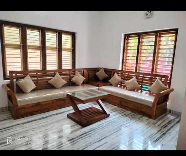 A Leading Teak Wood Interiors We Provide Affordable Cost And No Compromise in Quality In Works,Original Nilambur Teak Wood Only For All.Designing a living space with full teak wood furniture, such as a sofa set, and incorporating teak wood elements into the window interior design can create a warm, elegant, and timeless aesthetic. Teak wood is known for its durability, rich color, and natural resistance to moisture, making it an excellent choice for both furniture and interior design.Additional Pieces:Include a matching teak wood coffee table with a glass or wooden top.Add side tables or a console table in the same finish to maintain consistency.Incorporate teak wood bookshelves or a TV stand to complete the set.Styling Tips:Use throw pillows and blankets in earthy tones (olive green, mustard yellow, or terracotta) to add warmth.Place a natural fiber rug (jute or sisal) underneath the sofa set to enhance the organic feel.Decorate with brass or copper accents (lamps, vases, or trays) for a touch of luxury. Teak Wood Window Interior DesignTeak wood windows can add a touch of sophistication and warmth to your space. Here's how to incorporate them:Window Frames:Use teak wood for the window frames to create a seamless connection between the interior and exterior.Choose large windows to allow natural light to highlight the beauty of the teak wood.Window Treatments:Pair teak wood windows with simple, elegant curtains in linen or cotton fabrics. Neutral colors like white, beige, or light gray work well.Alternatively, use wooden blinds or bamboo shades to maintain a natural and cohesive look.Window Sills and Seating:Extend the teak wood design to the window sills, creating a functional space for plants or decor.Add a teak wood window seat with cushioned upholstery for a cozy reading nook.Styling Tips:Place potted plants or small indoor trees near the windows to enhance the natural vibe.Use teak wood shutters or panels for a rustic or tropical feel, depending on your overall theme.