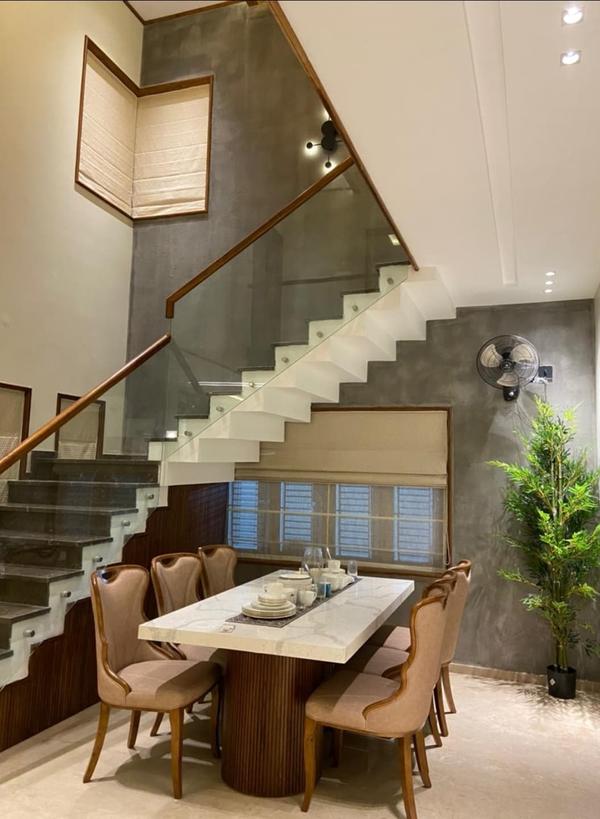 A Leading Teak Wood Interiors We Provide Affordable Cost And No Compromise in Quality In Works,Original Nilambur Teak Wood Only For All.Full Teak Wood Dining Table DesignKey Features:Material: Use solid teak wood for durability and a luxurious finish.Finish: Opt for a natural oil finish to highlight the wood's grain or a polished finish for a sleek look.Shape: Rectangular, oval, or round, depending on the space and style.Base Design:Traditional: Sturdy tapered legs or carved wooden legs.Modern: Sleek metal legs or a minimalist wooden pedestal base.Tabletop Thickness: 1.5 to 2 inches for a substantial, premium feel.Extensions: Consider a extendable design for added functionality.Full Teak Wood Dining Table DesignKey Features:Material: Use solid teak wood for durability and a luxurious finish.Finish: Opt for a natural oil finish to highlight the wood's grain or a polished finish for a sleek look.Shape: Rectangular, oval, or round, depending on the space and style.Base Design:Traditional: Sturdy tapered legs or carved wooden legs.Modern: Sleek metal legs or a minimalist wooden pedestal base.Tabletop Thickness: 1.5 to 2 inches for a substantial, premium feel.Extensions: Consider a extendable design for added functionality.Dimensions:Standard dining table height: 30 inches (76 cm).Length/Width: Adjust based on seating capacity (e.g., 6-seater: 72 x 36 inches)Teak Wood Staircase DesignKey Features:Material: Use solid teak wood for treads and handrails for durability and elegance.Finish: Natural oil or varnish to protect the wood and enhance its appearance.Design Style:Straight staircase: Simple and space-efficient.Spiral staircase: Compact and visually striking.Floating staircase: Modern and minimalist.Handrail: Teak wood handrails with optional metal or glass balustrades.Treads: Non-slip finish for safety.Design Ideas:Traditional Staircase:Carved wooden balusters and handrails.Ornate newel posts for a grand look.Modern Staircase:Floating teak treads with glass or metal railings.Minimalist design with clean lines.Rustic Staircase:Reclaimed teak wood with a weathered finish.Simple, sturdy design with exposed wood grain.Dimensions:Tread depth: 10-11 inches.Riser height: 7-8 inches.Handrail height: 34-38 inches (standard).Maintenance Tips for Teak Wood:Clean regularly with a soft cloth and mild soap.Apply teak oil or sealant annually to maintain the wood's lustre.Protect from direct sunlight to prevent fading.