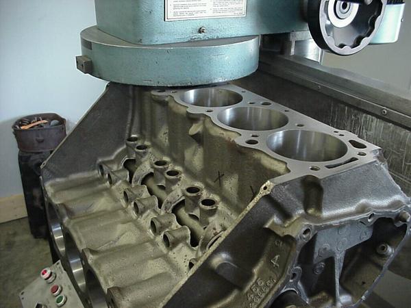 ### **Cylinder Head and Block Resurfacing**  **Cylinder head and block resurfacing** is the process of machining the mating surfaces of the engine block and cylinder head to ensure **perfect flatness, proper sealing, and optimal compression**. This is crucial for preventing **head gasket failures, coolant leaks, and compression loss**.  ---## **1. When is Resurfacing Needed?**  ✔ **Overheating damage (warped head/block)**  ✔ **Blown head gasket (gasket imprint or erosion on surface)**  ✔ **Corrosion, pitting, or surface irregularities**  ✔ **Engine rebuilding or performance upgrades**  ---## **2. Cylinder Head and Block Resurfacing Process**  ### **🔧 Step 1: Inspection & Preparation**  - **Check for warping or unevenness** using a **straight edge and feeler gauge** (specs vary by engine, typically under **0.002”-0.005”** deviation).  - **Look for cracks, deep grooves, or corrosion** (minor damage can be resurfaced; severe damage may require replacement).  - **Remove all components** (valves, camshafts, head gasket, and dowel pins).  - **Clean the surface** to remove carbon deposits, oil, and debris.  ---### **🛠 Step 2: Machining the Surface**  #### **1. Milling (Machine Resurfacing) – Most Precise Method**  - Uses a **CNC milling machine or belt sander** to remove a precise amount of material.  - Achieves a **smooth, even surface** with minimal material removal.  - Ideal for modern engines with **MLS (Multi-Layer Steel) head gaskets** requiring a finer surface finish (**RA 20-30 μin**).  #### **2. Grinding (For Cast Iron Heads & Blocks)**  - Uses a **rotating stone** to remove material evenly.  - Produces a rougher surface, more suitable for **composite or copper head gaskets**.  - Not recommended for **aluminum heads with MLS gaskets** due to the need for a finer finish.  #### **3. Lapping (Hand Resurfacing for Minor Repairs)**  - Uses **lapping compound** and a flat plate to **manually remove small imperfections**.  - Not ideal for severely warped heads but useful for **final finishing**.  ---### **⚙ Step 3: Final Checks & Reassembly**  - **Measure final surface finish (RA - Roughness Average)** to match gasket type.  - **Check thickness** to ensure proper compression ratio and valve clearance.  - **Reinstall the head using a new gasket** and torque bolts to manufacturer specs.  ---## **3. Why Cylinder Head & Block Resurfacing is Important?**  ✅ Ensures **proper sealing** to prevent coolant and oil leaks.  ✅ Restores **flatness**, preventing head gasket failure.  ✅ Improves **compression and combustion efficiency**.  ✅ Extends **engine life and reliability**.  Would you like recommendations on resurfacing tools or troubleshooting warpage issues? 🔧🚗