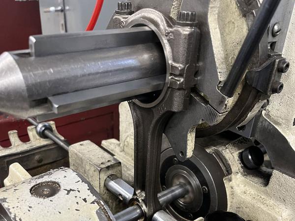 ### **Connecting Rod Boring and Grinding**  **Connecting rod boring and grinding** are essential machining processes to restore the **big end and small end** of the rod, ensuring proper alignment and fitment with the crankshaft and piston pin. These steps help maintain optimal engine performance and longevity.  ---## **1. Connecting Rod Boring**  Boring is done when the **big end bore (crankshaft journal end) or small end bore (wrist pin end)** becomes worn, out-of-round, or misaligned due to wear, overheating, or improper assembly.  ### **Steps for Connecting Rod Boring:**  🔧 **Inspection & Measurement:**  - Use a **dial bore gauge or micrometer** to check bore diameter and roundness.  - If excessive wear is found, determine the required **oversize or insert replacement**.  🔧 **Machining Process:**  - Secure the connecting rod in a **rod boring machine**.  - Align the boring tool precisely with the existing bore centerline.  - Bore the **big end** and **small end** to the correct diameter in multiple passes.  🔧 **Final Check:**  - Measure the bore to ensure it matches the manufacturer’s specifications.  - If needed, install **new bushings** in the small end and ream them to size.  ---## **2. Connecting Rod Grinding**  Grinding is performed to **restore the parting surface** of the rod and cap for a perfect mating surface. This ensures correct bearing crush and clearance.  ### **Steps for Connecting Rod Grinding:**  🛠 **Surface Grinding (Rod and Cap):**  - Secure the **rod and cap** in a precision grinding machine.  - Lightly grind the mating surfaces to achieve a **flat and true surface**.  - Maintain **proper material removal** to avoid excess reduction in size.  🛠 **Final Resizing (After Grinding):**  - After grinding, the big end bore becomes smaller.  - The rod is then **re-bored or honed** back to the correct size.  - Verify dimensions to ensure proper bearing fit.  ---### **Why Connecting Rod Boring and Grinding Matter?**  ✅ Ensures **proper bearing clearance**, reducing friction and wear.  ✅ Restores **correct alignment**, preventing crankshaft stress.  ✅ Increases **engine reliability** by preventing bearing failure.  Would you like recommendations on tools or troubleshooting misalignment issues? 🔧