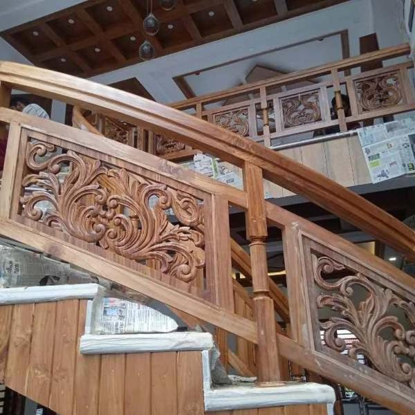 A Leading Teak Wood Interiors We Provide Affordable Cost And No Compromise in Quality In Works,Original Nilambur Teak Wood Only For All.A full teak wood staircase is a premium, durable, and aesthetically pleasing choice for both residential and commercial spacesFeatures of a Full Teak Wood Staircase 1.Material – Made entirely of high-grade teak wood (Tectona grandis), known for its strength and longevity. 2.Natural Finish – Retains the wood’s golden-brown hue, which ages to a silvery-gray patina if left untreated. 3.Durability – Resistant to warping, cracking, and insect damage due to natural oils. 4.Low Maintenance – Requires minimal upkeep; occasional polishing or oiling enhances its lifespan. 5.Design Options – Available in modern, traditional, or custom designs (straight, spiral, L-shaped, U-shaped, floating). 6.Safety & Comfort – Non-slip finishes can be applied for better traction.Components of a Teak Wood Staircase 1.Treads & Risers – Solid teak steps for a sturdy feel. 2.Handrails & Balusters – Smooth, ergonomic teak railings with wooden/metal spindles. 3.Newel Posts – Thick teak posts for structural support and elegance. 4.Stringers – Teak side supports (closed or open design).Maintenance Tips 1.Clean with a damp cloth and mild soap. 2.Apply teak oil/sealer annually (if maintaining golden-brown colour). 3.Avoid harsh chemicals or excessive water
