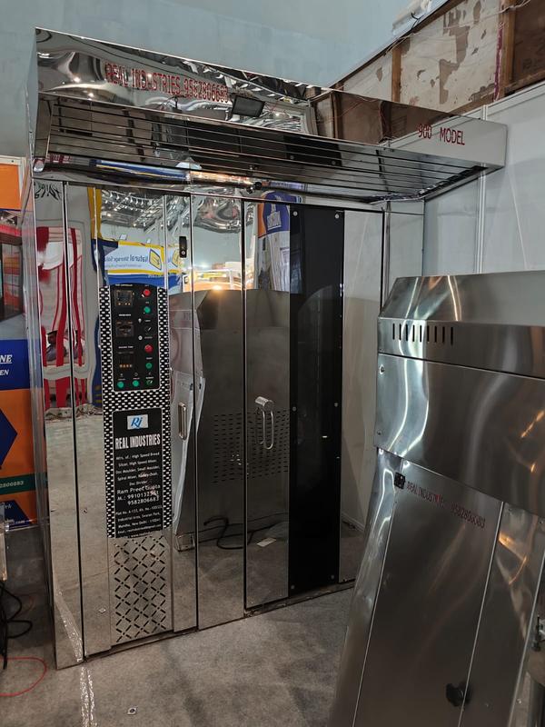 A rotary oven is a type of industrial baking oven commonly used in commercial bakeries and food production. It is designed to bake large quantities of food evenly and efficiently. The oven typically operates by rotating the baking trays or shelves inside the chamber, which ensures that the heat is distributed evenly, resulting in uniformly baked goods.

Here are some key features of a rotary oven:

Rotating Chamber: The baking trays or racks rotate inside the oven, allowing for consistent heat exposure on all sides of the food, ensuring even cooking and browning.

Air Circulation: Many rotary ovens use forced air systems to circulate hot air, further enhancing even heat distribution and cooking consistency.

Temperature Control: Rotary ovens are typically equipped with precise temperature controls, allowing operators to set the desired temperature for different types of products.

Efficiency: Rotary ovens are known for their energy efficiency, as the rotating racks ensure the heat is used effectively, reducing waste.

Capacity: These ovens often have a larger capacity compared to traditional ovens, making them ideal for bakeries that need to produce large quantities of food, such as bread, pastries, and pizza.

Versatility: Rotary ovens can be used for a wide variety of products, from baked goods to pizza and even meats, depending on the oven’s specifications.

Would you like to know more about how they work or their applications?



