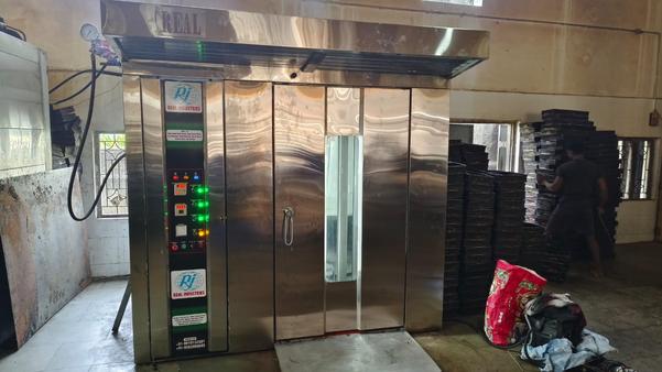 The Real Industries 88 Tray Rotary Rack Oven is a high-performance, large-capacity baking solution ideal for commercial bakeries, food production facilities, and other industries that require efficient and consistent baking. Known for its robust build, innovative design, and cutting-edge technology, this oven is a cornerstone in baking equipment that helps increase productivity while ensuring high-quality results.Overview of the Real Industries 88 Tray Rotary Rack OvenThe Real Industries 88 Tray Rotary Rack Oven is specifically designed to handle a high volume of baked goods. With a spacious tray capacity of 88 trays, this oven is perfect for large-scale production. It utilizes a rotary rack system, allowing uniform heat distribution for consistent baking and an even result across all trays.Key FeaturesLarge Capacity:With a tray capacity of 88 trays, the rotary rack oven can accommodate large batches of various baked products, from bread to pastries. This allows for high-volume production without compromising on quality.Rotary Rack System:The unique rotary rack system allows for even and consistent baking. The racks rotate inside the oven, ensuring that each tray receives the same amount of heat. This feature eliminates the need for multiple oven adjustments during the baking process, providing consistent results.Energy Efficiency:The Real Industries 88 Tray Rotary Rack Oven is designed to be energy-efficient, utilizing advanced heat circulation techniques that minimize energy consumption while maintaining optimal baking temperatures.Advanced Temperature Control:The oven comes with precise temperature control settings, allowing users to tailor the baking environment for various recipes. This ensures that every product, whether it's bread, cakes, or pastries, is baked to perfection.Durable Construction:Built with heavy-duty materials, the oven is designed to withstand the rigors of commercial use. The steel construction and high-quality insulation provide durability and longevity, ensuring years of reliable performance.Multiple Modes:The oven often comes with multiple baking modes, allowing operators to choose the ideal heat settings for different types of goods. Whether you’re baking bread, pastries, or pies, the oven can adjust the baking profile accordingly.Automated Functions:To improve efficiency, the oven may feature automated functions such as automatic loading/unloading systems, timer-based programming, and integrated controls for optimized performance.Improved Air Circulation:The rotary rack oven incorporates an advanced air circulation system that ensures even heat distribution, which is critical for uniform baking. This helps prevent hot or cold spots in the oven, ensuring that each batch is baked uniformly, regardless of its placement inside the oven.User-Friendly Control Panel:Equipped with an intuitive control panel, the oven is easy to operate. The user-friendly interface allows bakers and operators to adjust the settings quickly and accurately for each baking cycle.Hygienic Design:Hygiene is paramount in any food production environment. The Real Industries 88 Tray Rotary Rack Oven is designed with smooth, easy-to-clean surfaces that minimize the risk of cross-contamination. This is particularly important when working with different types of baked goods.Performance and EfficiencyThe 88 Tray Rotary Rack Oven is engineered to provide outstanding performance, particularly in high-demand environments. With its rotary rack system, the oven ensures uniform heating of the trays, minimizing baking inconsistencies. This is especially crucial in professional settings, where production volumes are high and any variation in bake quality can be detrimental.Baking consistency is further ensured through features like programmable controls, which allow bakers to set specific time and temperature parameters for different types of products. These precise settings are crucial for maintaining consistency across batches, whether the items being baked are delicate pastries or robust loaves of bread.ApplicationsThe Real Industries 88 Tray Rotary Rack Oven is suitable for a wide range of baking applications, including but not limited to:Bread: Whether you’re baking artisan loaves or mass-produced bread, the oven offers optimal heat distribution for perfect crusts and soft interiors.Pastries: The precise control of the oven makes it ideal for pastries that require delicate baking processes, ensuring they rise and crisp perfectly.Cakes and Pies: The oven's even heat and adjustable settings make it perfect for baking cakes and pies that require consistent results.Cookies: For bakeries producing large batches of cookies, this oven can handle high-volume baking while keeping each cookie perfectly golden and evenly baked.Advantages of the 88 Tray Rotary Rack OvenIncreased Production Efficiency: With its large capacity and rotary system, this oven allows bakeries to bake large batches of products simultaneously, reducing downtime and increasing overall productivity.Energy Savings: The advanced design helps to reduce energy consumption, making it a more sustainable option compared to other traditional baking methods.Improved Product Quality: The even heat distribution and consistent baking environment improve the overall quality of baked goods, leading to fewer reworks or spoiled batches.Reduced Labor Costs: The automated features and efficient design reduce the need for constant monitoring, enabling bakery staff to focus on other tasks, thus optimizing labor productivity.Maintenance and LongevityThe Real Industries 88 Tray Rotary Rack Oven is designed to require minimal maintenance, but regular servicing and cleaning are necessary to keep the equipment in optimal working condition. Routine maintenance ensures the longevity of the oven, keeping it running efficiently and extending its service life. Key components such as the fan, burners, and control systems should be inspected periodically, and the oven should be cleaned to prevent the buildup of food debris, which could affect performance and hygiene.ConclusionThe Real Industries 88 Tray Rotary Rack Oven is a top-tier solution for high-volume bakeries and food production facilities. Its combination of large capacity, uniform baking, energy efficiency, and durability makes it an ideal investment for businesses looking to scale their production while maintaining high product quality. With features that cater to a wide range of baking needs and an intuitive control system, this oven stands out as a reliable and essential tool for any large-scale bakery.