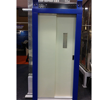 Telescopic elevator doors operate by sliding two or more panels in the same direction. As the elevator arrives at a floor, each panel slides behind the other, creating a wider door opening without needing extra wall space. This design is especially useful in buildings where a center-opening door system isn't feasible due to space constraints.The panels are synchronized using a geared motor, belt or chain drive system, and guided by rollers for smooth operation. The mechanism allows fast, efficient door movement with minimal noise, making them ideal for both residential and commercial applications.