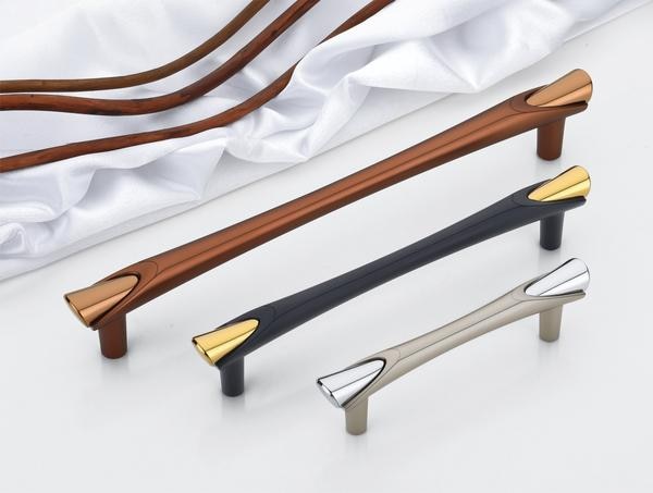 Elegant cabinet or door handles, present a striking modern aesthetic with a focus on contrasting finishes. Each handle features a sleek, elongated form with distinct metallic accents at the ends, adding a touch of sophistication to any wardrobe or door. The available finishes include a warm bronze with polished brass end caps, a contemporary matte black with gleaming gold accents, and a refined silver or grey with chrome detailing, potentially achieved through a durable PVD finish for enhanced longevity and resistance to wear.These handles are designed with a commitment to both visual appeal and lasting performance. The use of high-quality, corrosion-resistant materials ensures that they can withstand daily use without losing their elegant appearance over time. The sleek design is characterized by smooth lines and a comfortable grip, enhancing the functionality and aesthetic of the furniture or doors they adorn.While primarily intended as handles for wardrobes and doors, the premium quality and durable finishes suggest a level of craftsmanship that aligns with high-end hardware. The PVD finish, if utilized, would provide a robust protective layer against scratches, fading, and corrosion, making these handles a practical and stylish choice for various settings.The variety of finishes – brass accents, matte finish, and potentially PVD finish – allows for versatile application across different design styles. The bronze with brass accents offers a touch of classic warmth, the matte black with gold provides a bold and modern contrast, and the silver/grey with chrome detailing offers a sleek and contemporary feel. This range ensures seamless integration with existing hardware and décor.