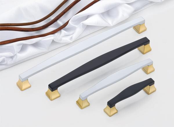 A curated selection of cabinet handles, presents a compelling study in contrasting textures and finishes, ideally suited for enhancing modern wardrobes or doors. Each handle features a smoothly contoured central bar, available in either a sophisticated matte black or a sleek, brushed silver, offering a comfortable and ergonomic grip. The mounting bases at each end flare into distinctive, geometric forms finished in a warm, lustrous brass, creating a striking visual counterpoint to the central bar.These handles are meticulously fashioned, emphasizing both aesthetic sophistication and enduring resilience. Fabricated from high-caliber, corrosion-resistant alloys, they are engineered to withstand the rigors of frequent use without succumbing to wear or environmental degradation, ensuring their refined appearance persists over time. The sleek design, characterized by the clean lines of the central bar and the bold geometry of the brass bases, imparts a distinctly modern flair, elevating the overall design of the furniture or doors they adorn.While these are primarily intended as handles for wardrobes and doors, their superior construction and the potential application of a durable PVD finish (particularly on the silver variants for enhanced longevity) suggest a level of quality commensurate with high-end hardware. A PVD coating, renowned for its exceptional hardness and resistance to scratching, fading, and corrosion, would render these handles a pragmatic yet stylish selection for diverse interior environments.The deliberate juxtaposition of finishes – the matte black or brushed silver against the polished brass – facilitates versatile integration with a wide spectrum of design palettes. The matte black offers a grounding element with a touch of contemporary minimalism, the brushed silver provides a sleek and industrial-chic aesthetic, while the brass accents introduce a note of warmth and understated luxury, enabling these handles to harmonize with both cool and warm color schemes and various material selections within a space.Although the keywords 