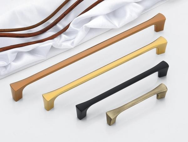 A distinguished collection of handles, identified as DP-CH-011 Cabinet & Wardrobe Handles, presents a study in refined minimalism and diverse material interpretations, ideally suited for enhancing contemporary wardrobes or doors. Each handle features a subtly contoured, elongated bar that offers a comfortable and ergonomic grip, seamlessly transitioning into clean, rectilinear mounting bases at either extremity. The available finishes showcase a spectrum of modern aesthetics, encompassing a lustrous, polished brass, a warm and inviting bronze or copper hue, a sophisticated, velvety matte black, and a refined silver or grey, with the potential application of a resilient PVD finish on select variants for augmented longevity and a touch of understated luxury.The design of these handles emphasizes uncluttered lines and a smooth, continuous flow, cultivating an aura of understated sophistication. The gentle curvature of the central bar introduces a note of ergonomic consideration, while the crisp, geometric bases provide a contemporary anchor point. This harmonious synthesis of subtle arcs and sharp angles ensures that these handles complement a broad spectrum of interior design narratives, spanning from minimalist to transitional.Constructed from high-grade, corrosion-resistant alloys, these handles are engineered to endure the demands of everyday interaction without succumbing to wear or environmental degradation, ensuring their refined appearance persists over time. The potential incorporation of a PVD finish, particularly on the metallic iterations, further bolsters their durability, imparting a robust protective stratum against scratches, fading, and corrosion, rendering them a pragmatic yet stylish selection for diverse interior milieus.The curated selection of finishes – brass finish, bronze/copper tone, matte finish, and silver/grey (potentially PVD finish) – facilitates versatile integration with a wide array of design palettes. The polished brass imparts a touch of classic warmth, the bronze/copper introduces a sense of richness and depth, the matte black provides a contemporary and understated elegance, while the silver/grey offers a sleek and modern sophistication. This spectrum ensures seamless consonance with existing hardware and décor, allowing for a cohesive and stylish ambiance throughout a space.