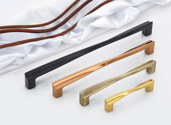 A collection of handles, known as DP-CH-012 for cabinets and wardrobes, presents a modern aesthetic with varied material expressions, designed to enhance your  wardrobe doors . Each handle features a distinctively shaped, elongated bar, offering a comfortable grip, seamlessly connected to sturdy, angular mounting base, and more over is slim to provide comfort .The available finishes include polished brass for a classic touch, bronze or copper for warmth, matte black for a modern feel, and silver or grey, potentially with a durable PVD coating for added longevity and subtle elegance.The design emphasizes a balance between form and function. The uniquely contoured central bar provides both visual interest and a tactile experience, while the strong, geometric bases offer a contemporary foundation. This deliberate combination of flowing lines and sharp angles allows these handles to complement a range of interior styles.Constructed from high-quality, corrosion-resistant alloys, these handles are built to withstand daily use, maintaining their refined appearance over time. The potential use of a PVD finish, especially on the metallic options, further enhances their durability, providing protection against wear and tear.The selection of finishes – brass, bronze/copper, matte black, and silver/grey (potentially PVD) – allows for versatile integration with different design preferences. Brass offers traditional appeal, matte black provides modern simplicity, while bronze/copper adds richness, and silver/grey offers sleekness.