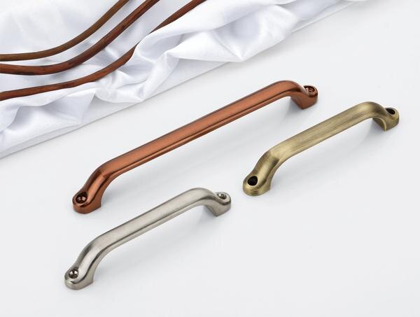 The image showcases three elegantly designed metallic pull handles arranged on a clean white surface, with soft white fabric and curved copper rods in the background. These handles come in different metallic finishes: a warm copper/rose gold at the top, a brushed nickel/silver in the middle, and an antique brass/gold at the bottom. Each handle features a sleek, elongated design with gently curved ends and visible mounting screws at both ends.These window handles exemplify contemporary comfort and slim design principles. Their streamlined silhouette represents new generation design thinking that balances aesthetics with functionality. The ergonomic shape allows for a comfortable grip when opening or closing windows, while the slim profile ensures they don't visually overwhelm the window frame.The varied metallic finishes offer versatility to complement different interior design schemes - from modern minimalist to traditional spaces. These handles serve as both functional hardware and subtle design accents for windows.The rounded edges and smooth surfaces enhance user comfort, eliminating sharp corners for safety. Their durable metal construction suggests longevity, while the clean, uncluttered design aligns with contemporary preferences for refined simplicity in home hardware. These handles represent how even utilitarian elements can be reimagined as design features in modern window systems.