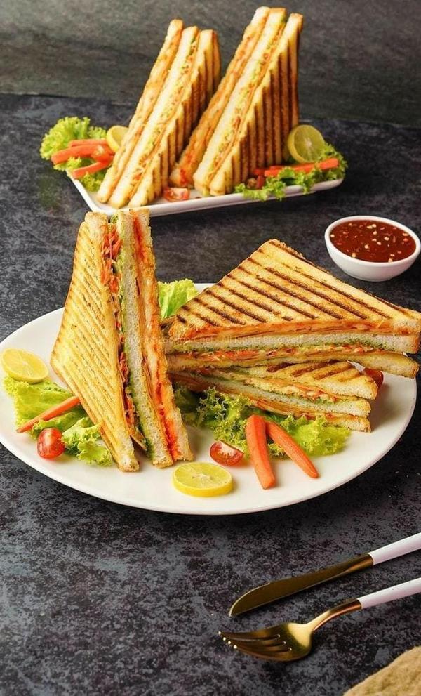 Grilled Sandwich, Golden, crispy bread grilled to perfection, filled with a mouthwatering blend of melted cheese, fresh vegetables, and your choice of savory meats or plant-based options. Every bite offers a satisfying crunch and a warm, gooey center perfect for a quick lunch or a comforting 