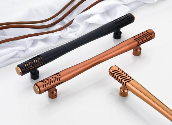 Where craftsmanship meets creativity—this exclusive main door handle collection is a true work of art. Featuring a precision-cut pattern that adds both texture and intrigue, these handles stand out with a play of solid and void, making them as much a design statement as they are a functional element.The silhouette is sleek and tapered, while the ends boast detailed laser-cut accents, finished with bold metallic caps. Whether you choose the striking matte black with copper highlights or the rich satin bronze tones, each piece exudes refined elegance and bold innovation.Crafted with premium PVD coating for durability and a 3-year warranty, these handles are ideal for homeowners looking to add a dramatic, high-design touch to their main entrances.