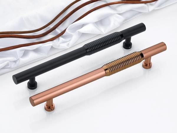 Step into a realm of bold sophistication with this captivating series of modern door handles—where form, function, and flair merge into one seamless experience. Designed with a focus on linear precision and sculptural elegance, each handle features an elongated silhouette enhanced by deeply grooved details that not only provide a firm, confident grip but also infuse the design with an industrial-inspired rhythm. These grooves aren't just visual elements—they are the very essence of tactile sophistication.Every curve and contour is engineered to perfection, offering a smooth yet commanding presence that draws the eye and engages the touch. The finishes are nothing short of stunning. From the moody intensity of satin matte black to the radiant brilliance of mirror-finished rose gold with a grooved brass core, these handles offer a bold aesthetic for spaces that prioritize both edge and elegance. Crafted using advanced PVD coating technology, these handles resist corrosion, fading, and everyday wear, ensuring their brilliance remains untouched over time. Backed by a 3-year guarantee, they are not just about style—they promise lasting performance and security. Created for the new generation that values minimalism with a dramatic twist, this collection stands as a symbol of purposeful design. It’s not just hardware—it’s a statement, a testament to refined taste and fearless creativity.