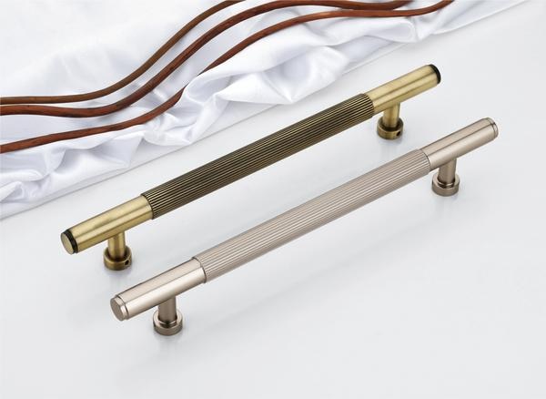  Elevate contemporary interiors with this striking pair of door handles that redefine tactile luxury and refined craftsmanship. Merging clean tubular geometry with intricately fluted grip zones, these handles are a tribute to industrial precision and understated elegance. Each piece speaks to those who appreciate subtle textures and commanding details—design elements that are felt as much as they are seen.The rich, brushed brass variant exudes timeless charm with a vintage edge, while the satin champagne finish offers a soft, modern glow—both designed to stand out yet complement a wide range of décor styles. The flawlessly grooved detailing not only enhances grip and functionality but delivers an artisanal character that feels exclusive and sophisticated. Constructed with durability in mind, these handles are coated in a high-performance PVD finish that resists tarnishing, corrosion, and scratches, making them ideal for both main doors and high-traffic interior spaces. Their seamless silhouette and robust foundation ensure years of dependable use, backed confidently by a 3-year guarantee. These handles are more than just functional hardware—they are a designer’s signature, a homeowner’s pride, and a new-generation choice for elegant, safe, and unique architectural statements.