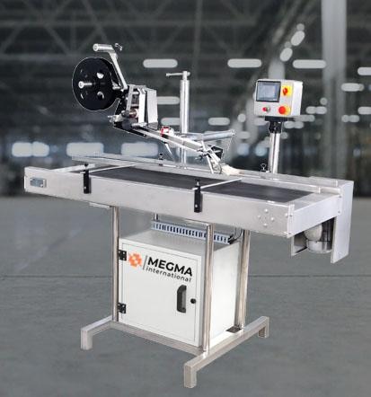 Megma international's Automatic Top and Bottom Sticker Labeling Machine is an advanced labeling system designed to apply self-adhesive labels on both the top and bottom surfaces of flat or slightly curved products. It ensures highprecision, efficiency, and consistency, making it ideal for industries such as food & beverages, pharmaceuticals, cosmetics, electronics, and consumergoods.The machine operates with a conveyor system, where products are automatically fed into the labeling station. Two synchronized label applicators precisely dispense and apply labels on both the top and bottom of the product. Advanced sensors ensure accurate label placement, while a roller or brush system secures firm adhesion.The machine has a touchscreen control panel with a PLC, which makes it simple to operate and customizes the label position and speed.  It is an adaptable solution for cartons, pouches, boxes, food trays, and electronic gadgets since it supports a variety of label materials, such as paper, plastic, translucent, and holographic labels.