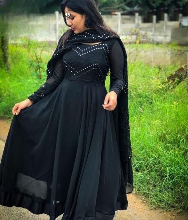 PALSANA Present Embrace timeless elegance with our Black Embroidered Gown, a masterpiece that seamlessly blends traditional craftsmanship with contemporary design. This ensemble features luxurious fabrics and intricate embroidery, perfect for special occasions.Crafted from luxurious georgette fabric, this gown features intricate zari thread and sequin embroidery on the front and back, adding a touch of opulence to your ensemble. The rich black hue exudes sophistication and versatility, making it a perfect choice for weddings, festive occasions, or any special celebration.The accompanying net dupatta adds a layer of grace, featuring delicate patterns that complement the gown's intricate embroidery. Its lightweight and airy fabric ensure comfort without compromising on style.Fabric: Premium Georgette for a fluid and flattering silhouette.Embroidery: Detailed zari and sequin work on the front and back.Dupatta: Georgette fabric with matching borders, crafted from soft Georgette fabric.Fit: Fitted at the bust and waist, flaring gracefully towards the hem.Occasions: Ideal for weddings, receptions, festive gatherings, and formal events.