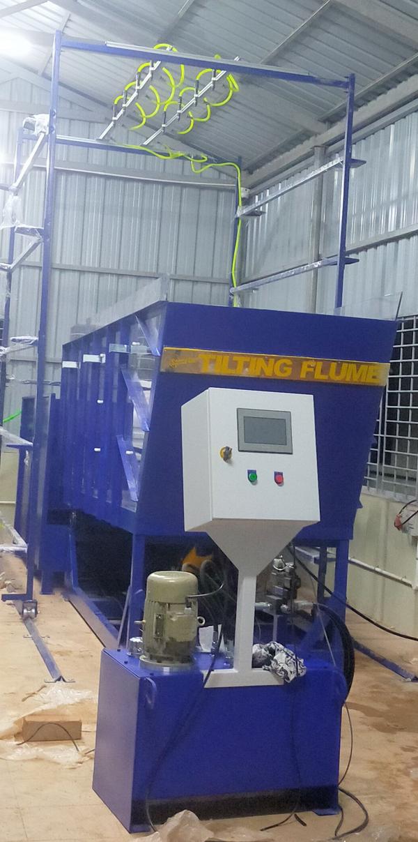 A Tilting Flume is a hydraulics laboratory apparatus used to study open channel flow under controlled conditions. It is called 'tilting' because the slope of the flume bed can be adjusted to simulate different gradient conditions found in natural streams, rivers, or irrigation canals.