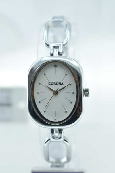 This beautiful silver plated watch has an oval white dial and a silver band. It has an adjustable buckle closure and a one-piece metal case. It also has a scratch resistant crystal face and water resistant.