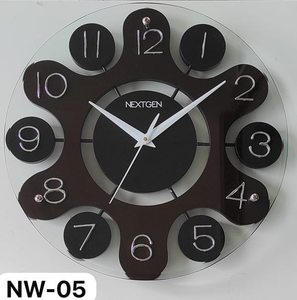 Introducing the stylish WOODEN/GLASS CLOCK NW-05 from our Wooden Clock category. Featuring a sleek brown dial, a wooden frame, and a contemporary design, this clock is the perfect addition to any space. Powered by a Quartz clock mechanism, it is both accurate and reliable. Made from high-quality wood, this clock comes in a classic wooden color. Elevate your decor with this stunning timepiece.