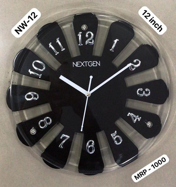 Introducing the stylish WOODEN CLOCK NW-12 for your home or office. This clock features a classic brown dial enclosed in a wooden frame, perfect for a contemporary theme. The clock mechanism is quartz for accurate timekeeping. Made of high-quality wood, this clock is durable and long-lasting. Add this unique piece to your collection today!