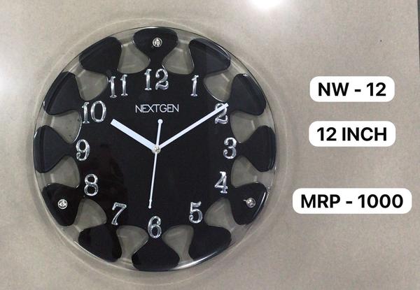 Introducing the stylish WOODEN/GLASS CLOCK NW-12 for your home or office. This clock features a classic brown dial enclosed in a wooden frame, perfect for a contemporary theme. The clock mechanism is quartz for accurate timekeeping. Made of high-quality wood, this clock is durable and long-lasting. Add this unique piece to your collection today!