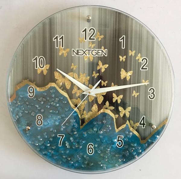 EXCLUSIVE RANGE OF DUAL GLASS WALL CLOCKS WITH RESIN WORK INSIDE.