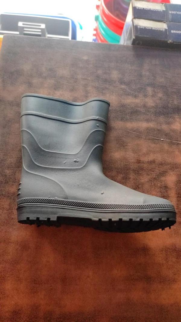 Gum boots, also known as Wellington boots or rubber boots, are waterproof footwear designed to protect feet from wet and muddy conditions. Typically made from rubber or PVC, they are durable, flexible, and easy to clean. Commonly used in agriculture, construction, fishing, and outdoor activities, gum boots provide excellent protection against water, chemicals, and debris. Many designs include slip-resistant soles for better traction and insulated linings for warmth in colder environments. Their tall shafts keep legs dry, making them ideal for working in rain or wetlands. Both functional and practical, gum boots are essential gear for many outdoor professionals and enthusiasts.