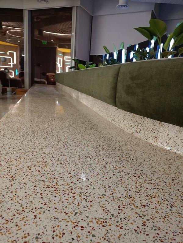 Terrazzo FlooringTerrazzo flooring is a stylish and durable surface made by embedding marble, quartz, granite, or glass chips into a cement or epoxy base, then polishing it to a smooth finish. Known for its seamless appearance, low maintenance, and exceptional longevity, terrazzo is ideal for both residential and commercial spaces. Its customizable design options make it a popular choice for creating elegant and timeless interiors.Benefits of Terrazzo FlooringDurability – Highly resistant to wear, cracking, and heavy foot traffic, making it ideal for long-term use.Low Maintenance – Easy to clean and requires minimal upkeep; resists stains and moisture.Customizable Design – Available in a wide range of colors and patterns to suit any interior style.Eco-Friendly – Often made with recycled materials and contributes to sustainable building practices.Seamless Finish – Creates a smooth, joint-free surface that enhances both aesthetics and hygiene.Cost-Effective Over Time – Though the initial investment may be higher, its longevity and low maintenance reduce overall costs.