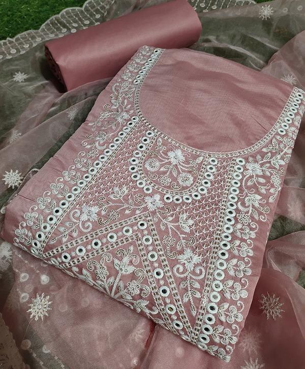 Add a soft and elegant charm to your ethnic wardrobe with this beautiful pink unstitched dress material, delicately adorned with embroidery and complemented by a graceful Chanderi dupatta. Designed for festive wear and special occasions, this set blends traditional aesthetics with a touch of modern grace.Top Fabric: Premium fabric (cotton/silk/chanderi blend – based on actual material), in a soothing pink shade with intricate embroidery that enhances its feminine appeal.Bottom Fabric: Plain dyed matching fabric, soft and breathable, suitable for custom tailoring.Dupatta: Lightweight Chanderi dupatta with subtle woven motifs and elegant borders for a refined, festive look.Color: Soft Pink – timeless, radiant, and perfect for day or evening functions.Style: Unstitched – tailor it into your desired style: straight-cut, A-line, or Anarkali.Occasion: Ideal for festive celebrations, weddings, pujas, and traditional gatherings.Highlights:Beautiful embroidery detailing on the topElegant Chanderi dupatta with a graceful drapeSoft, pastel tone for a fresh and classic lookUnstitched set for custom fit and styling flexibilityPerfect for traditional yet modern ethnic wear loversCare Instructions:Dry clean only to maintain embroidery and Chanderi fabric quality.