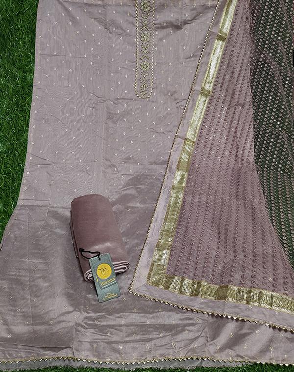 Add a soft and feminine charm to your ethnic wardrobe with this exquisite pink unstitched dress material, adorned with delicate embroidery and paired with a matching dupatta. This ensemble offers a perfect blend of traditional craftsmanship and modern style, ideal for festive occasions, casual gatherings, or special celebrations.Top Fabric: Premium quality fabric (cotton/silk/chanderi blend as applicable) in a gentle pink shade, featuring intricate embroidery that enhances its elegance.Bottom Fabric: Coordinated plain dyed fabric, comfortable and easy to tailor.Dupatta: Matching dupatta with subtle embroidery or woven detailing, completing the graceful look.Color: Soft Pink – timeless and flattering for all skin tones.Style: Unstitched – tailor to your desired style such as straight-cut, A-line, or Anarkali.Occasion: Perfect for weddings, festive functions, or casual ethnic wear.Highlights:Beautiful embroidery adds sophisticationLightweight and breathable fabric for comfortSoft pink hue for a fresh and elegant appearanceUnstitched for personalized fitting and stylingCoordinated dupatta for a complete ethnic ensembleCare Instructions:Dry clean recommended to preserve embroidery and fabric quality.