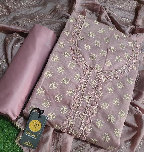 Step into timeless elegance with this charming Pink Handwork Dress Material with Dupatta. Crafted with care, the top fabric is beautifully adorned with intricate hand embroidery, showcasing skilled craftsmanship and delicate detailing. The soft pink hue adds a touch of grace and femininity, making it perfect for festive occasions, traditional functions, or daytime celebrations.Product Details:Color: Soft/Blush Pink (depending on actual tone)Top Fabric: Pure Cotton / Chanderi / Silk Blend / GeorgetteBottom Fabric: Matching Cotton / Santoon / SilkDupatta: Hand-Embroidered / Printed / Contrast Net or ChiffonWork: Delicate Handwork – Thread, Bead, Mirror, or Zardozi (based on actual design)Type: Unstitched Dress MaterialStyle: Straight Cut / A-line / Semi-stitched (tailor to your taste)Occasion: Festive, Ethnic Functions, Mehendi, Haldi, Day EventsKey Highlights:Soft and soothing pink color for a graceful ethnic lookDetailed hand embroidery for a truly artisanal touchIdeal for custom stitching – can be tailored to a unique fitComes with a coordinated dupatta for a complete ensemblePerfect for weddings, family gatherings, and festive wear