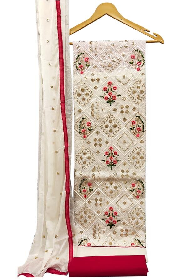 Embrace timeless elegance with this exquisite White Embroidered Floral Chanderi Dress Material with Dupatta. Perfectly blending traditional craftsmanship with modern grace, this unstitched ensemble is crafted for women who appreciate classic beauty and soft sophistication. The rich texture of Chanderi fabric paired with delicate floral embroidery creates an effortlessly graceful look.Top Material: Luxurious white Chanderi fabric delicately adorned with floral embroidery, featuring fine thread work that adds subtle texture, charm, and an ethereal touch to your look.Bottom Material: Complementing cotton or Chanderi blend fabric in matching or light contrasting tones, offering comfort and versatility for all-day wear.Dupatta: Coordinated Chanderi dupatta with light embroidery or printed floral accents and a bordered finish, adding a refined and flowy touch to the full outfit.Key Features:Fabric: Chanderi (Top & Dupatta), Cotton/Chanderi Blend (Bottom)Work: Fine Floral EmbroideryColor: Classic White with Subtle Multi-thread EmbroideryType: Unstitched — perfect for customizing into your desired ethnic styleOccasion: Ideal for festive occasions, pujas, formal events, and day functionsCare Instructions: Dry clean preferred to maintain embroidery and fabric sheenFabric Measurements:Top: Approx. 2.5 metersBottom: Approx. 2.5 metersDupatta: Approx. 2.25 meters