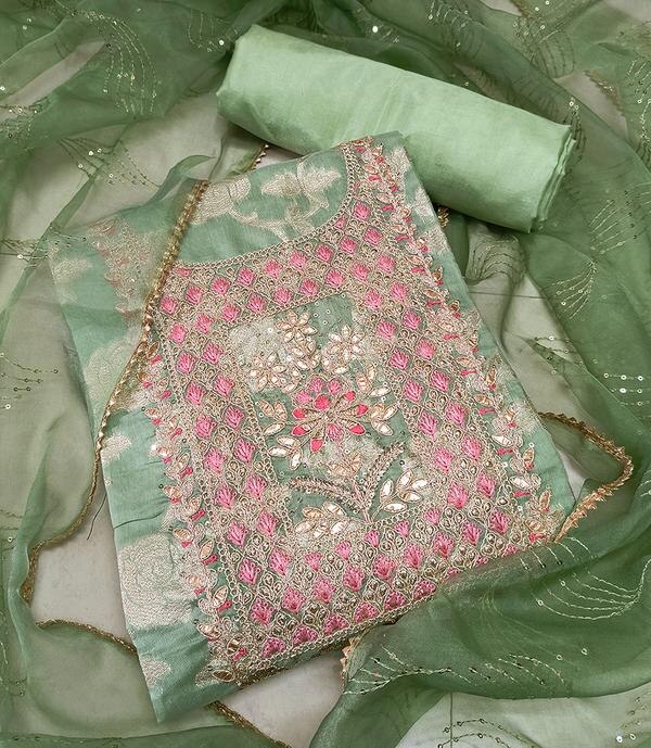 Step into graceful tradition with a modern twist with this Green Embroidered Dress Material paired with a Jacquard Dupatta. Crafted for women who value both comfort and couture, this unstitched suit set showcases intricate embroidery on soft fabric, beautifully matched with a textured jacquard dupatta that adds a regal touch. Ideal for festive occasions, casual functions, or elegant everyday wear.Top Material: Smooth and breathable fabric in a fresh green tone, delicately enhanced with fine thread embroidery—adding subtle detail and visual richness to the overall look.Bottom Material: Matching or contrast cotton or blended fabric, offering comfort, flexibility, and a perfect finish for a complete outfit.Dupatta: Statement-making jacquard dupatta featuring woven motifs or zari patterns, designed in complementary tones to elevate the entire ensemble with depth and texture.Key Features:Fabric: Cotton/Poly Blend (Top & Bottom), Jacquard (Dupatta)Work: Elegant Floral or Ethnic Embroidery on TopColor: Rich Green with Contrasting or Coordinated Jacquard DupattaType: Unstitched — suitable for straight-cut suits, Anarkalis, or churidarsOccasion: Great for festive events, poojas, family functions, and everyday ethnic wearCare Instructions: Dry clean recommended to maintain embroidery and dupatta textureFabric Length:Top: Approx. 2.5 metersBottom: Approx. 2.5 metersDupatta: Approx. 2.25 meters