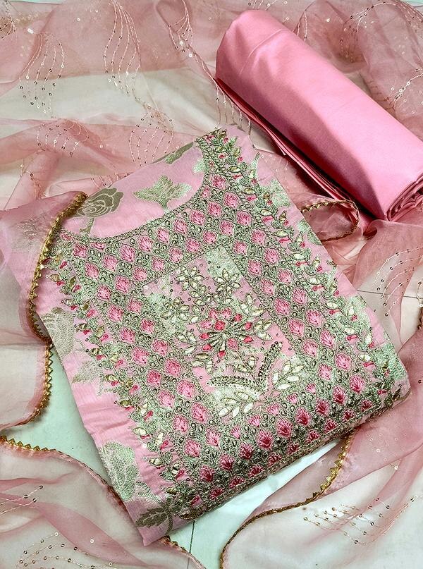 Elevate your ethnic wardrobe with this charming Pink Embroidered Dress Material paired with a Jacquard Dupatta. Perfect for women who love a blend of delicate artistry and vibrant color, this unstitched suit material features intricate embroidery on a soft pink fabric, complemented by a richly textured jacquard dupatta to add depth and sophistication to your look.Top Material: Soft, breathable fabric in a fresh pink shade, adorned with elegant thread embroidery showcasing floral or traditional motifs, enhancing the fabric’s richness and appeal.Bottom Material: Coordinated cotton or blended fabric, offering comfortable wear while complementing the embroidered top.Dupatta: Luxurious jacquard dupatta with exquisite woven designs or zari work, crafted in complementary pink hues to perfectly harmonize with the outfit.Key Features:Fabric: Cotton/Poly Blend (Top & Bottom), Jacquard (Dupatta)Work: Fine Embroidery Detailing on TopColor: Soft Pink with Coordinated Jacquard DupattaType: Unstitched — customize into your favorite ethnic silhouette (straight suit, Anarkali, churidar)Occasion: Ideal for festive celebrations, casual functions, traditional events, and elegant daywearCare Instructions: Dry clean recommended to maintain embroidery and fabric textureFabric Length:Top: Approx. 2.5 metersBottom: Approx. 2.5 metersDupatta: Approx. 2.25 meters