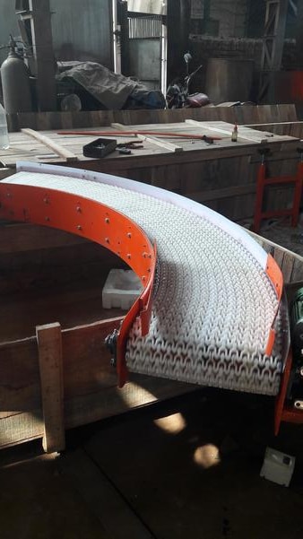 A modular belt conveyor is a versatile and durable material handling system used across industries like food processing, packaging, pharmaceuticals, and manufacturing. Below are details of what makes it special:What’s this?• Made of interlocking plastic or metal modules that form a continuous belt• Typically constructed from polypropylene, polyethylene, or acetal• Designed for easy maintenance—damaged sections can be replaced individuallyKey Advantages over conventional PVC belt • Customizable layout: Can be configured to curves, inclines, or declines• High durability: Withstands heavy loads and harsh environments• Easy to clean: Ideal for hygienic applications like food or pharma• Low noise & energy efficient: Smooth operation with minimal power usage• Food grade Safe: It can be safely used in Food & Pharma industry.• Safe transport: Flat surface minimizes product damage during movementCommon Applications• Transporting packaged goods, bottles, boxes, or delicate items• Used in automotive, logistics, electronics, and warehousing• Especially useful for wide or bulky products that need stable support