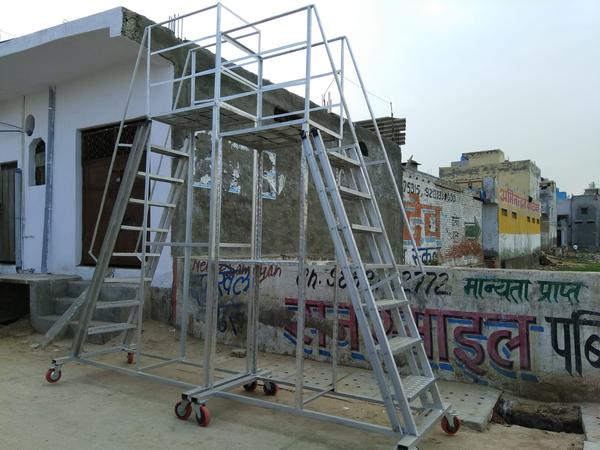aluminum trolley step ladder is a robust, mobile, and highly practical access solution designed for industrial, commercial, and warehouse use. Built from high-grade aluminum, this ladder combines lightweight portability with strength and durability. Its integrated trolley wheels allow easy relocation without lifting, making it ideal for frequent use across large workspaces.Key Features:Durable Aluminum Construction: Made from high-tensile, corrosion-resistant aluminum for a long service life and ease of handling.Trolley Design with Wheels:Equipped with non-marking castor wheels or tilt-and-roll wheels for smooth mobility.Most models feature spring-loaded or foot-activated locking mechanisms to ensure stability when in use.Wide Anti-Slip Steps: Deep, slip-resistant steps offer secure footing and comfort during extended use.Top Platform: A spacious top platform provides a stable working area, perfect for accessing elevated shelves or performing maintenance tasks.Safety Handrails & Guardrails: Many models include side handrails and a wraparound guardrail at the platform for enhanced user safety.Compact & Easy to Maneuver: Lightweight frame and wheel system make it easy to move around tight warehouse aisles or office storage areas.Common Sizes:Step heights range from 2 to 10 steps (approx. 2 to 10 feet / 0.6 to 3 meters)Platform size varies based on model but typically provides ample space for tools or small materials.Ideal Applications:Warehousing and inventory managementRetail stores and stockroomsLibraries and archivesOffice maintenanceLight industrial environmentsALUMINM TROLLY STEP LADDER - 10FT
