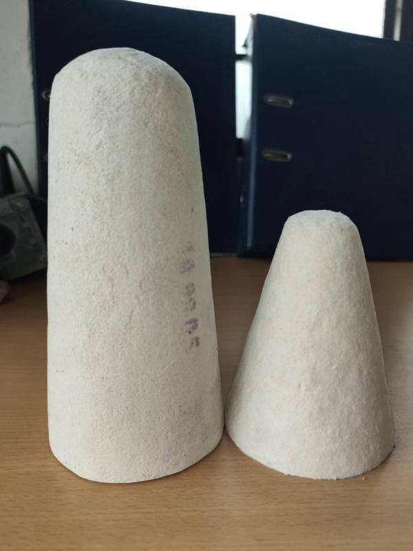 The Ceramic Fiber Cone Shroud is a precision-formed refractory component designed to control or stop the flow of molten aluminium or iron during casting processes. Made from high-purity ceramic fiber, it offers excellent thermal insulation, low thermal conductivity, and resistance to molten metal splash and thermal shock.Engineered for use in flow control systems in aluminium foundries, this cone-shaped shroud is lightweight yet durable, ensuring easy handling, quick replacement, and efficient flow regulation. Its insulation properties help maintain temperature stability while preventing unwanted metal leakage or overflow.✅ Key Features:Withstands temperatures up to 1260°CExcellent flow control during castingResists molten metal splash and erosionLightweight and easy to installReduces energy loss and improves safetyCustom sizes available for various furnace setups